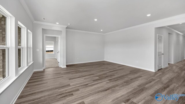 empty room with dark hardwood / wood-style flooring and ornamental molding