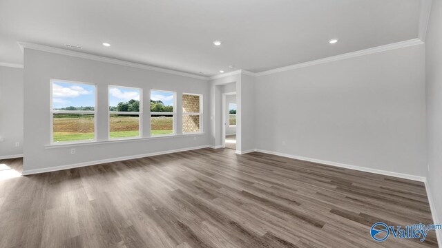 unfurnished room featuring crown molding and dark wood-type flooring