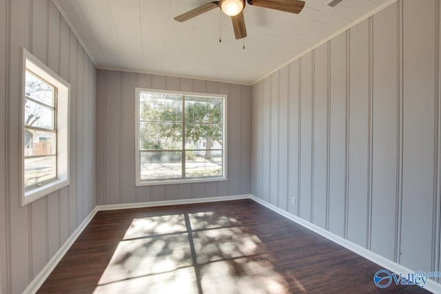 empty room featuring dark wood-type flooring and ceiling fan