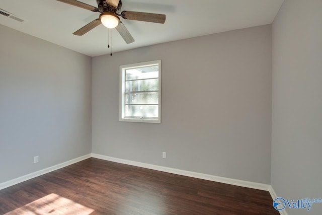 unfurnished room featuring ceiling fan and dark wood-type flooring