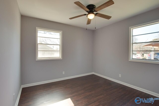 unfurnished room with ceiling fan and dark hardwood / wood-style flooring