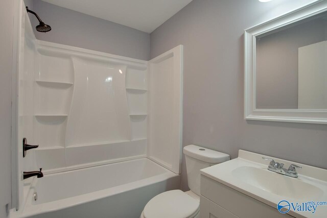 full bathroom featuring toilet, vanity, and  shower combination