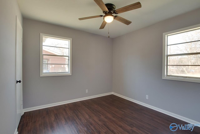 unfurnished room featuring ceiling fan, dark hardwood / wood-style floors, and a healthy amount of sunlight