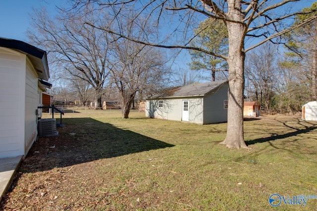 view of yard featuring cooling unit and a storage shed