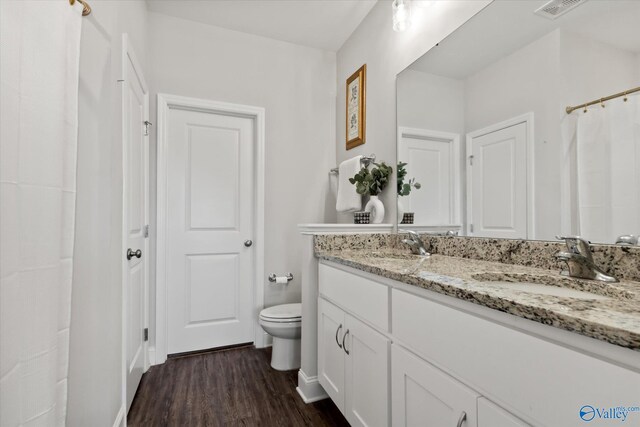 26674 Kyle Ln, Athens, AL 35613 - bathroom with toilet, wood finished floors, double vanity, and baseboards