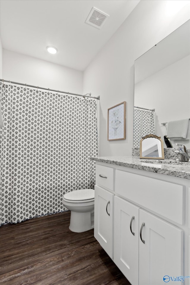 26674 Kyle Ln, Athens, AL 35613 - bathroom with toilet, vanity, wood finished floors, and a shower with shower curtain