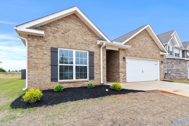 26674 Kyle Ln, Athens, AL 35613 - view of front of home with an attached garage, concrete driveway, brick siding, and a front yard