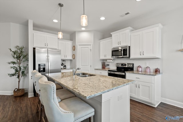 26674 Kyle Ln, Athens, AL 35613 - kitchen featuring appliances with stainless steel finishes, a sink, baseboards, recessed lighting, and a kitchen island with sink