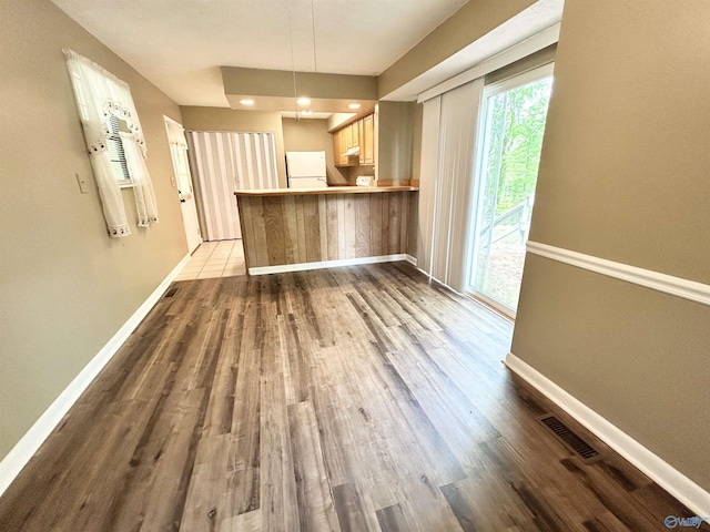1313 Barry Rd, Anniston, AL 36206 - unfurnished living room featuring visible vents, dark wood finished floors, and baseboards
