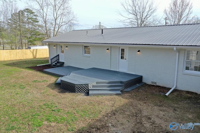 rear view of property featuring a yard and a deck