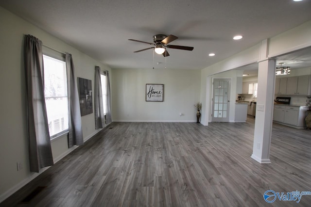 unfurnished living room with ceiling fan and light hardwood / wood-style flooring