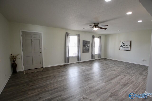 spare room with ceiling fan, hardwood / wood-style floors, and a textured ceiling