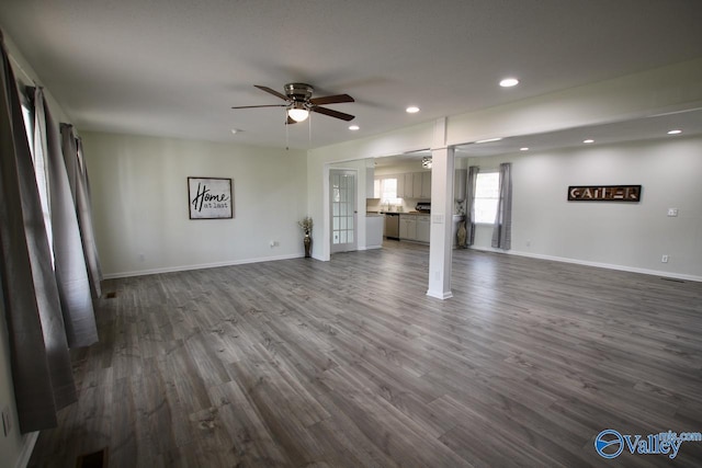 unfurnished living room with ceiling fan and dark hardwood / wood-style flooring