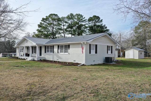 single story home with central AC unit, a storage shed, a front yard, and a porch