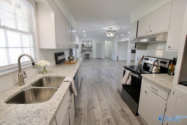 kitchen featuring sink, white cabinetry, stainless steel appliances, light stone counters, and tasteful backsplash