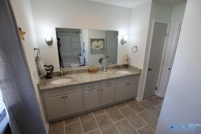 bathroom with vanity, tile patterned flooring, and toilet