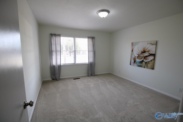 spare room with light colored carpet