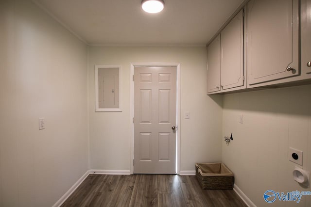 clothes washing area with electric dryer hookup, dark wood-type flooring, electric panel, and cabinets