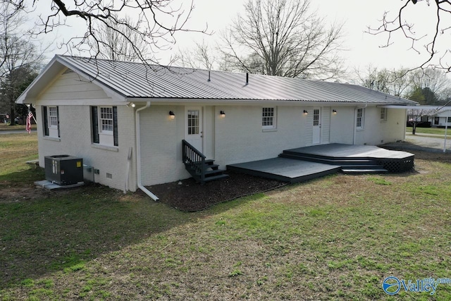back of property featuring central AC unit, a yard, and a wooden deck