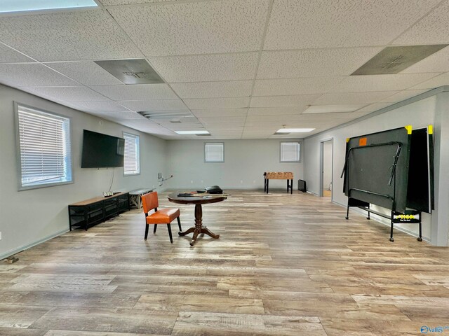 game room with a paneled ceiling and hardwood / wood-style floors