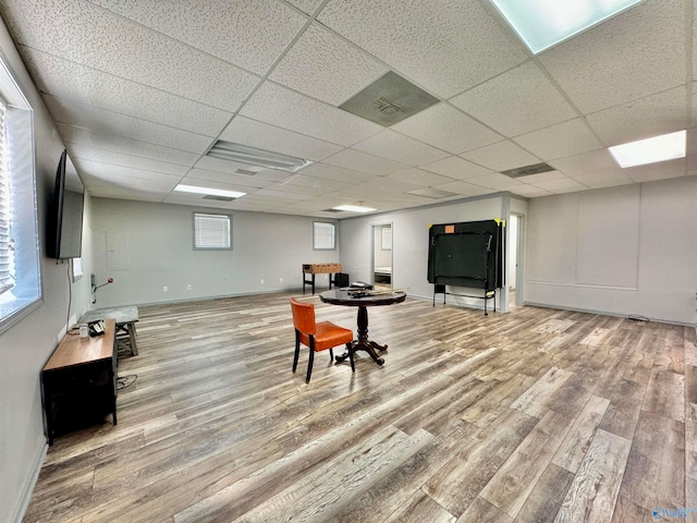 interior space featuring a paneled ceiling and light wood-type flooring