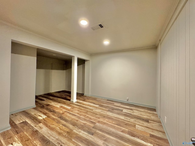 basement featuring hardwood / wood-style flooring and ornamental molding