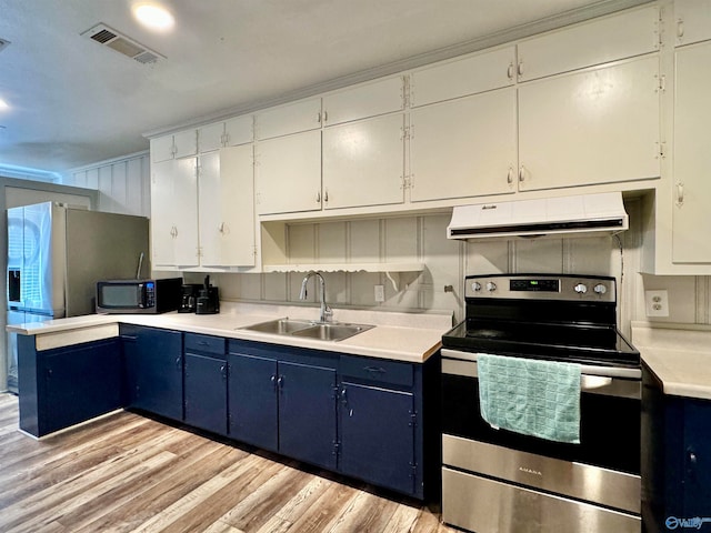 kitchen with white cabinets, appliances with stainless steel finishes, blue cabinetry, light hardwood / wood-style flooring, and sink