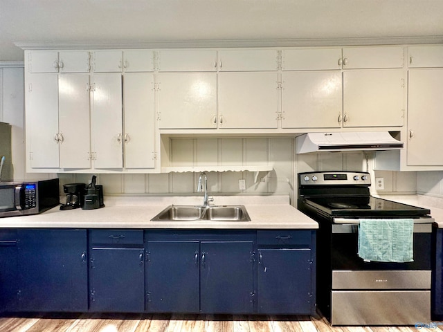 kitchen with appliances with stainless steel finishes, sink, white cabinetry, light hardwood / wood-style floors, and blue cabinetry