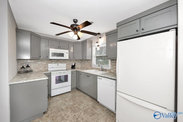 kitchen featuring gray cabinets, sink, white appliances, and decorative backsplash