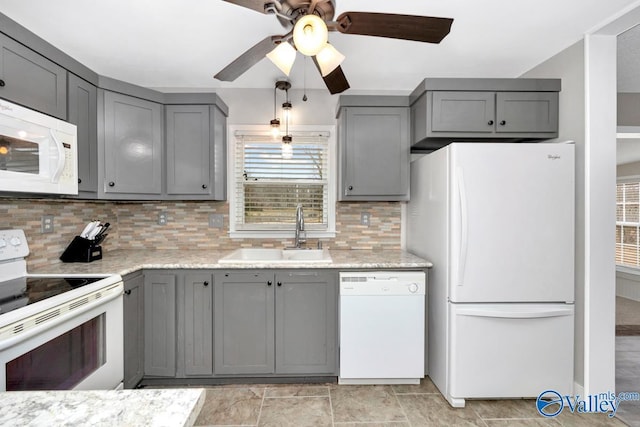 kitchen featuring sink, gray cabinetry, and white appliances