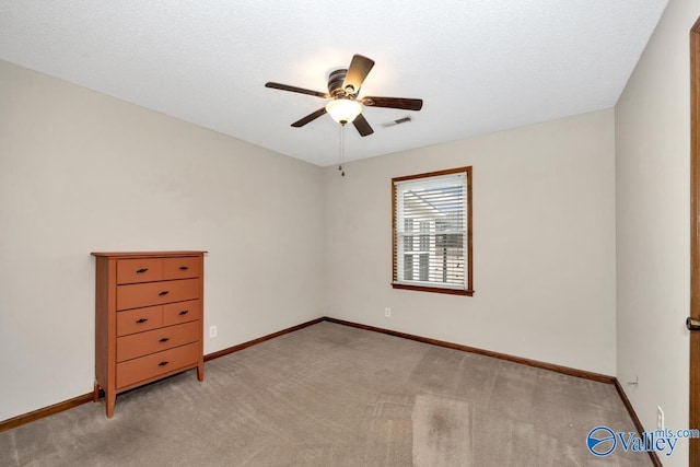 unfurnished room featuring light carpet and ceiling fan