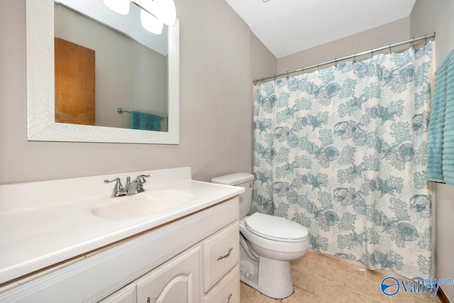 bathroom featuring vanity, tile patterned floors, and toilet