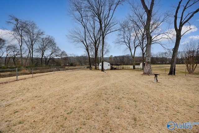 view of yard with a rural view and a shed