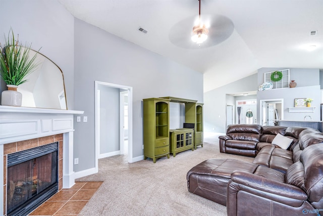 carpeted living room featuring a fireplace, ceiling fan, and high vaulted ceiling