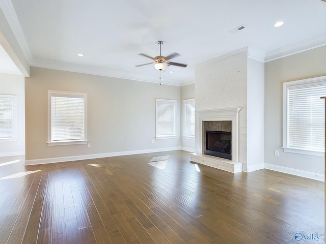 unfurnished living room with a healthy amount of sunlight and dark hardwood / wood-style flooring