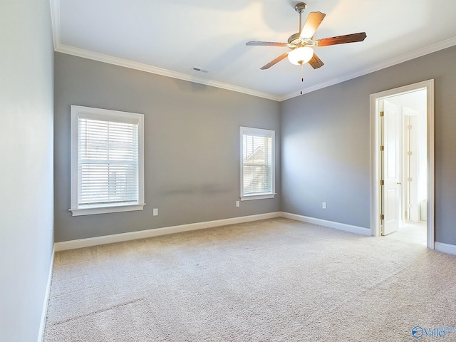 carpeted empty room featuring plenty of natural light, ceiling fan, and crown molding