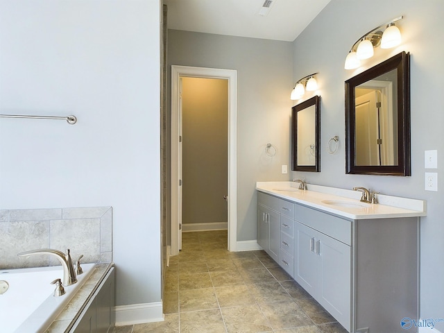 bathroom featuring tiled bath and vanity