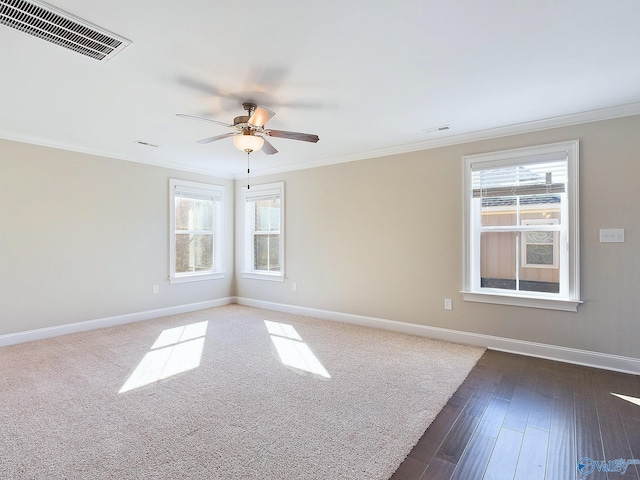 spare room featuring dark hardwood / wood-style floors, ceiling fan, and ornamental molding