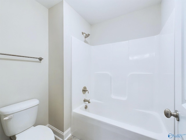 bathroom with bathtub / shower combination and toilet