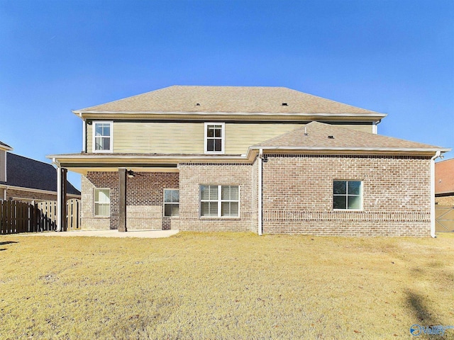 rear view of house with a yard