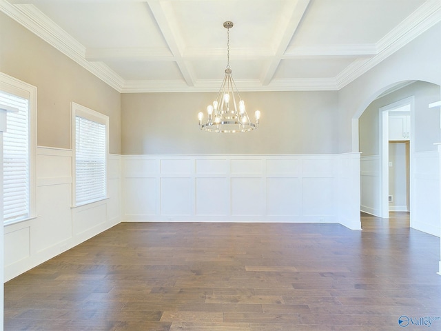 unfurnished room with dark wood-type flooring, an inviting chandelier, coffered ceiling, crown molding, and beam ceiling