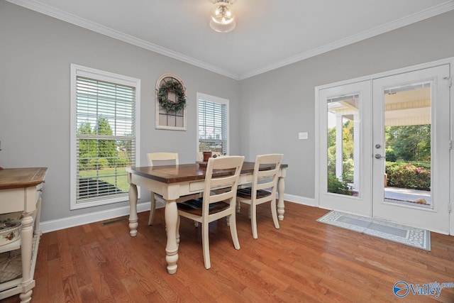 2961 Hobbs Island Rd SE, Huntsville, AL 35803 - dining room featuring crown molding, baseboards, french doors, and light wood-style floors