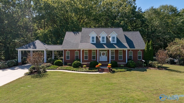 cape cod house featuring a front yard and a carport