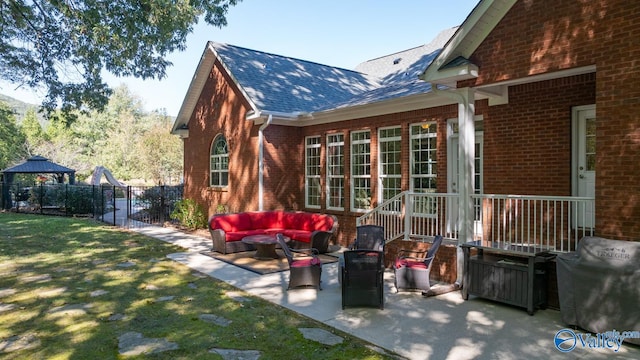 back of property with a patio, a yard, a gazebo, and an outdoor hangout area