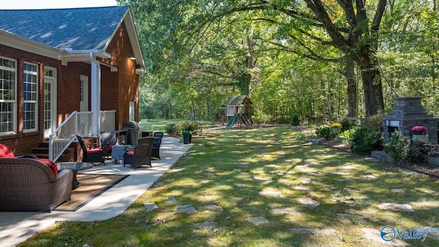 view of yard with a playground and a patio area