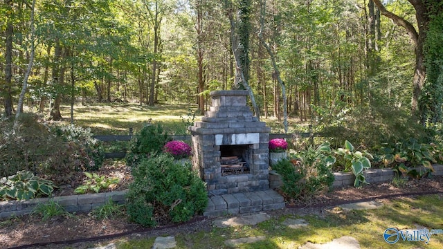 2961 Hobbs Island Rd SE, Huntsville, AL 35803 - exterior space featuring a view of trees and an outdoor brick fireplace