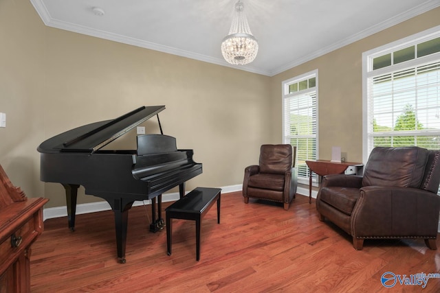 sitting room with ornamental molding, an inviting chandelier, and wood-type flooring