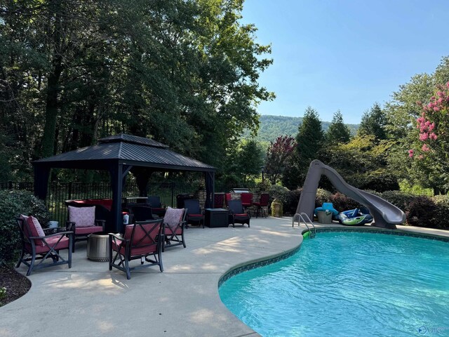 2961 Hobbs Island Rd SE, Huntsville, AL 35803 - pool featuring a patio, a gazebo, a water slide, and fence
