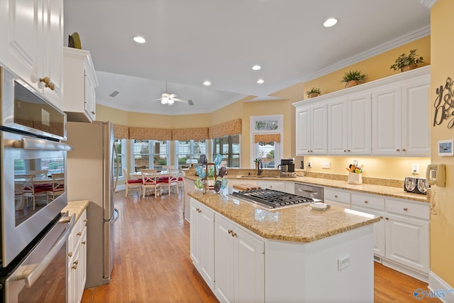 kitchen featuring light wood-type flooring, white cabinetry, and stainless steel appliances