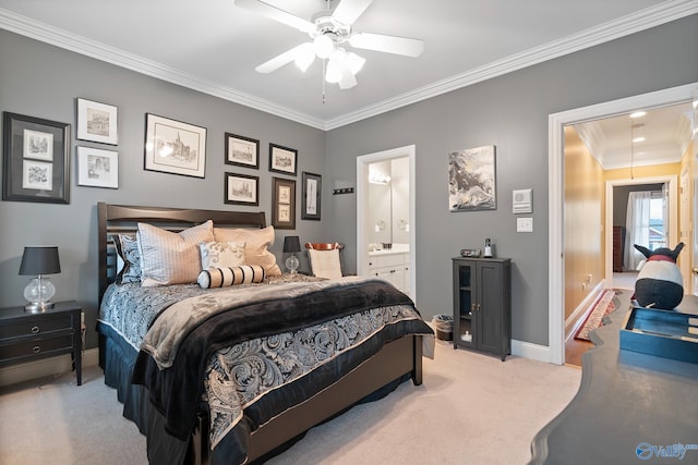 bedroom with light carpet, a ceiling fan, baseboards, ensuite bath, and crown molding